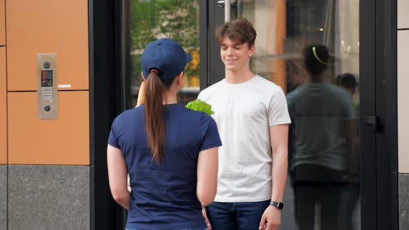Smiling Food Delivery Woman Courier with Paper Bag of Groceries Deliver Order alt