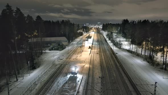 Small Tractors Pushing Snow Off of the Train Station Platform in Vantaa
