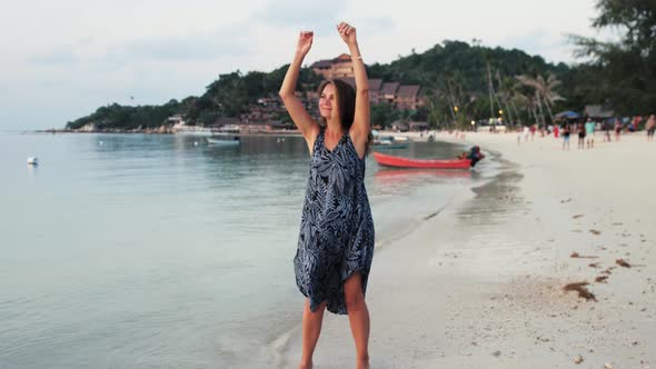 Young Woman Dancing Enjoying Vacation Travel on Tropical Beach