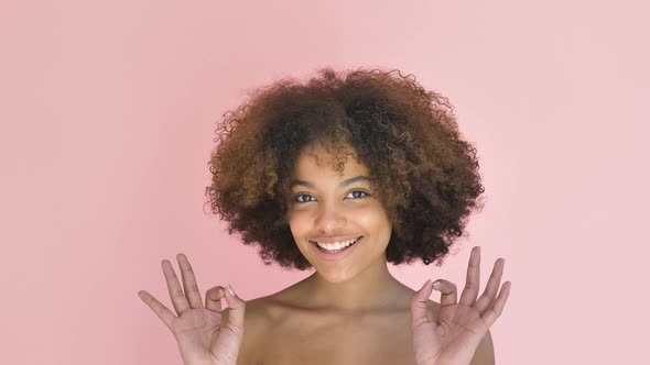 Cheerful Mixed Race Woman Shows Okay Sign Gesture Smiling alt