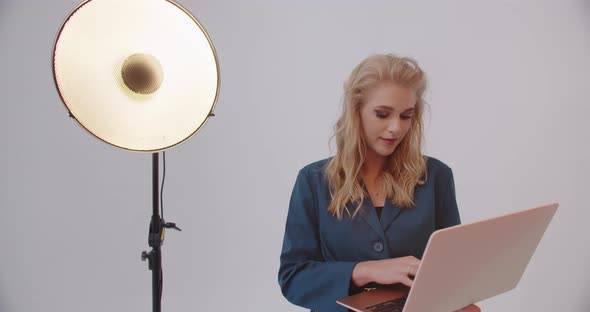 Girl Working On A Laptop In The Studio On A White Background