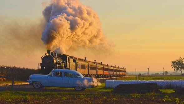 Steam Passenger Train Approaching With a Full Head of Steam at Sunrise alt