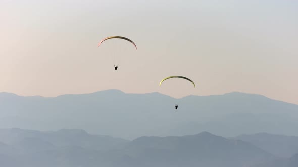 Paragliders Flying With Paragliding in Sky Over the Forest, Mountain Top and Sea alt