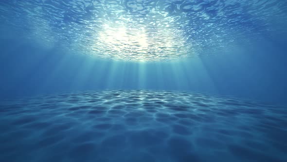 Blue ocean bottom with bubbles and light rays deep underwater