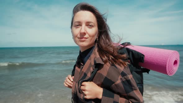 Portrait of female solo traveler against sea