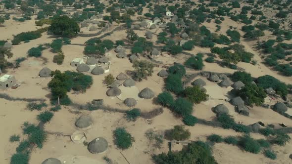 Aerial Over Rural Huts On The Ground In Tharparkar, Pakistan. Follow Shot alt