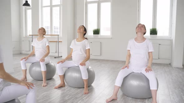 Happy Attractive Diverse Pregnant Women Practice Meditation Relaxation Training On Fitballs