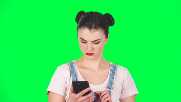 Portrait of Woman Speaking Via Telephone Looking Boredon Green Screen, Slow Motion alt