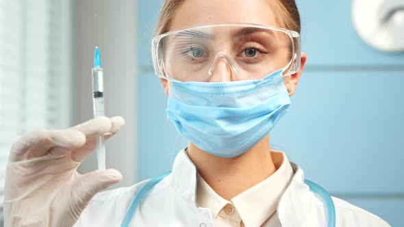 Concentrated young woman general practitioner in disposable mask alt