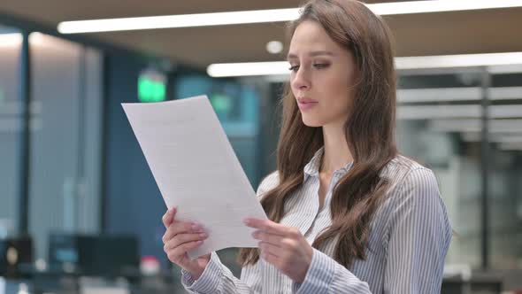 Portrait of Young Businesswoman Reading Documents alt