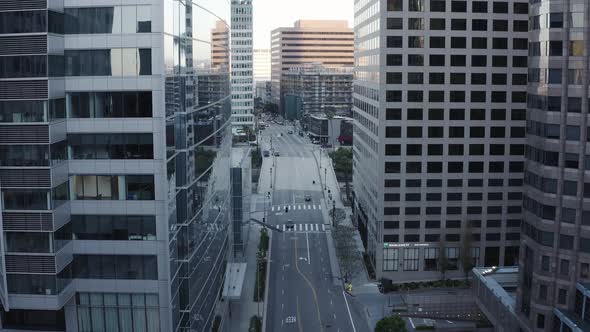 Flying over a downtown road in Los Angeles with empty streets in the middle of the day due to the gl alt