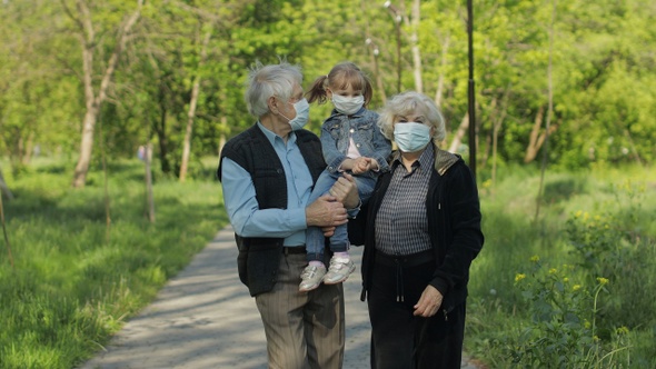 Family of Grandparents Takes Off Medical Masks After Coronavirus Quarantine End alt