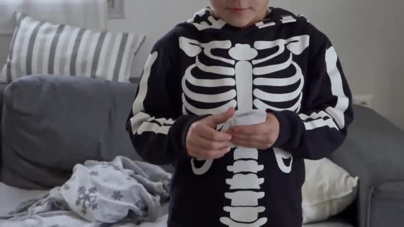 Close up on caucasian boy, counting fake monopoly money, tilt down shot alt