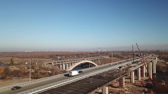 The bridge over the river. Car traffic on the bridge. View from the top. Drone aerial alt