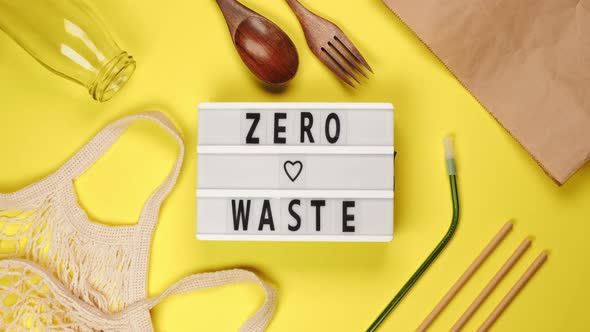 White board with Zero Waste lettering on yellow background with shopping bag