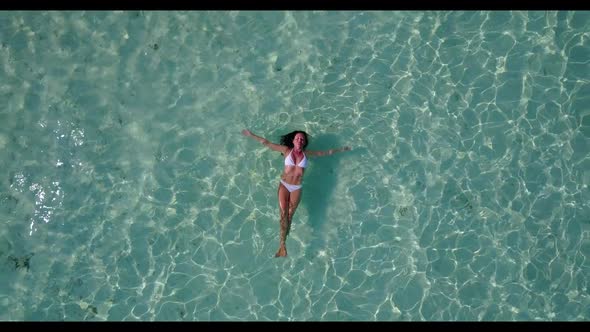 Single lady sunbathes on paradise resort beach time by shallow lagoon and white sand background of t alt