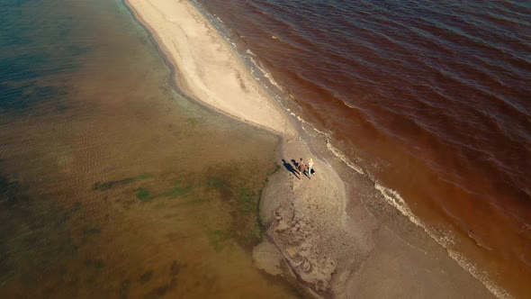 Aerial Slow Motion Traveling Couple Walking By Sand Beach Between Water Ukraine alt