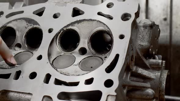 Mechanic in Car Service Took Off Valve Head of Engine and Shows Amount of Carbon Deposits Inside alt