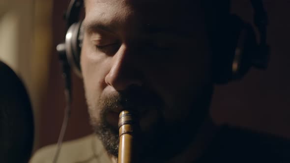 Musician Plays on Wooden Flute alt