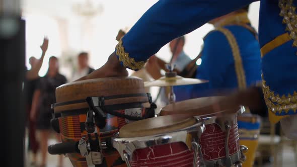 African Black Man Playing Drums in the Banquet Hall at the Party alt