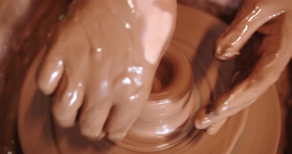 Pottery. Hands Form Ceramic Products From Clay By Means Of A Potter's Wheel