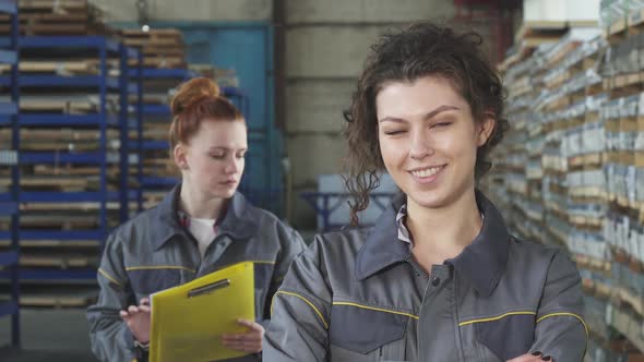 Beautiful Cheerful Female Factory Worker Smiling to the Camera alt