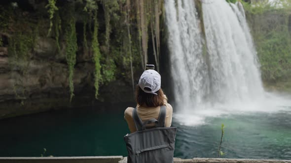 Attractive Smiling Woman Tourist Making Selfie on Mobile Phone on Upper Duden Waterfall Background alt