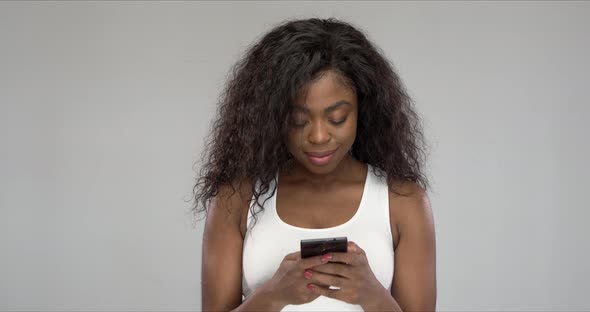 Happy African American Woman Using Smartphone