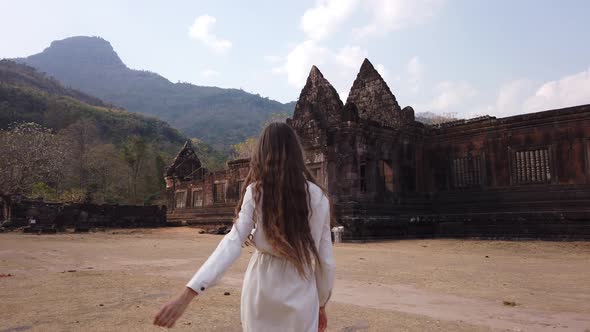 Beauty woman walk near ancient palace Vat Pou Hindu Temple Phu Kao mountain Laos, Asia, UNESCO, Slow alt