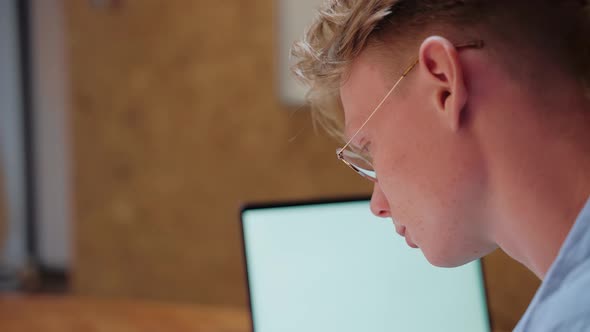 Closeup Shot of Young Man Studying at Home Writing Notes alt