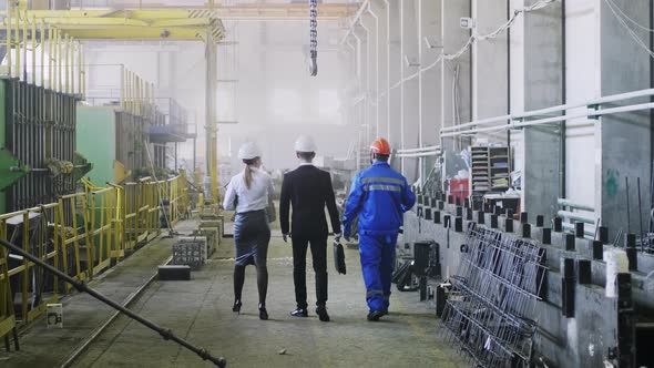 Managers going through factory with crew foreman