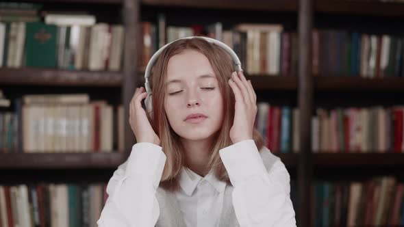 Cheerful Pupil Listening to Favorite Music with Headphones Moving to the Rhythm alt