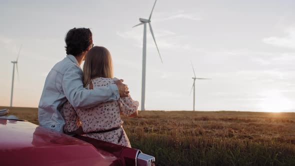 Rear view of couple hugging during sunset. Shot with RED helium camera in 8K. alt