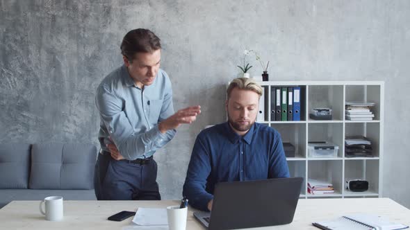 Two business persons are work together in modern office. Team of businessmen. alt