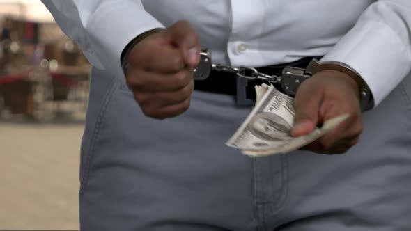Close Up Man in Handcuffs Holding Money alt