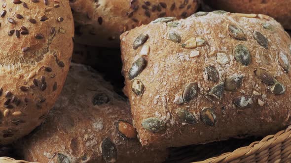 Wicker basket with selection of breads and pastries. Assortment of baked products 