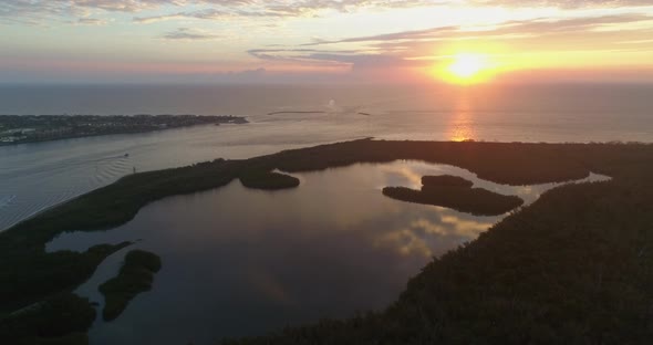 Sunset and Clouds Reflecting on Calm Water by Jupiters Island Florida alt