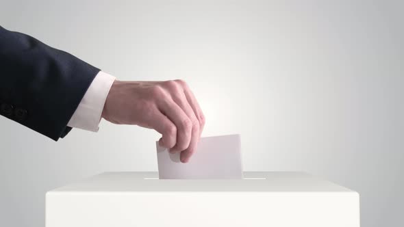 Voting. Hand Putting a Ballot into a Voting Box.