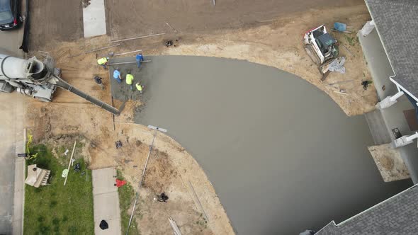 Birds eye view of concrete work for new driveway in residential neighborhood.