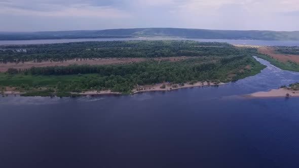 Drone is Flying Over Island in Middle of Wide River Volga in Summer Aerial View