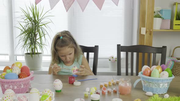 Girl Colors Eggs For The Bright Holiday Easter At Her Home alt