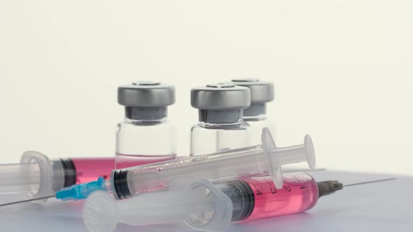 Syringes and Vials of Vaccine From the Virus Covid 19 alt