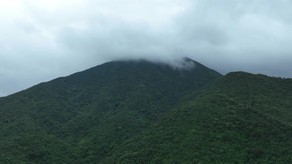 Aerial footage of green foggy forest mountain landscape in summer,Hyperlapse alt