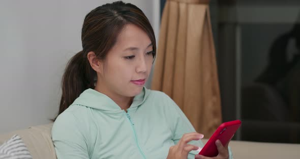 Woman use of mobile phone at home alt