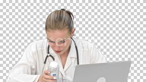 Young female doctor typing on laptop, Alpha Channel