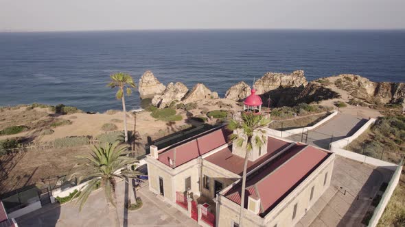 Dogs running on the grounds of Ponta da Piedade lighthouse and keeper's house, Algarve. alt