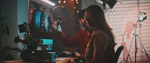 The film director is showing the clips and talking to the actress