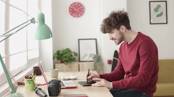 Hipster Young Graphic Designer Sketching on Tablet Working From Home Office alt
