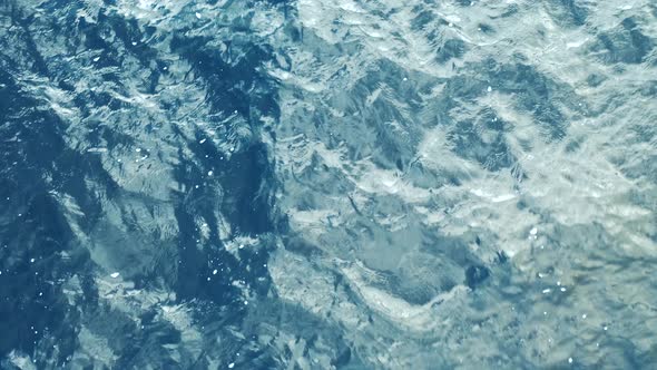 Aerial View of a Crystal clear sea water texture. Waves in motion
