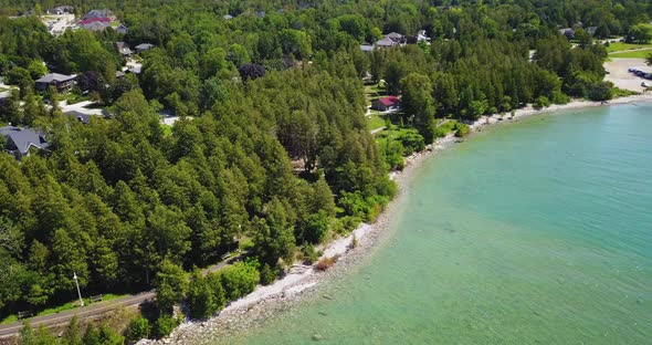 Gorgeous aerial flyover of the turquoise waters of Lake Huron along the Bruce Peninsula. alt